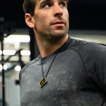 Man wearing Lifetune Flex EMF protection pendant in gym environment